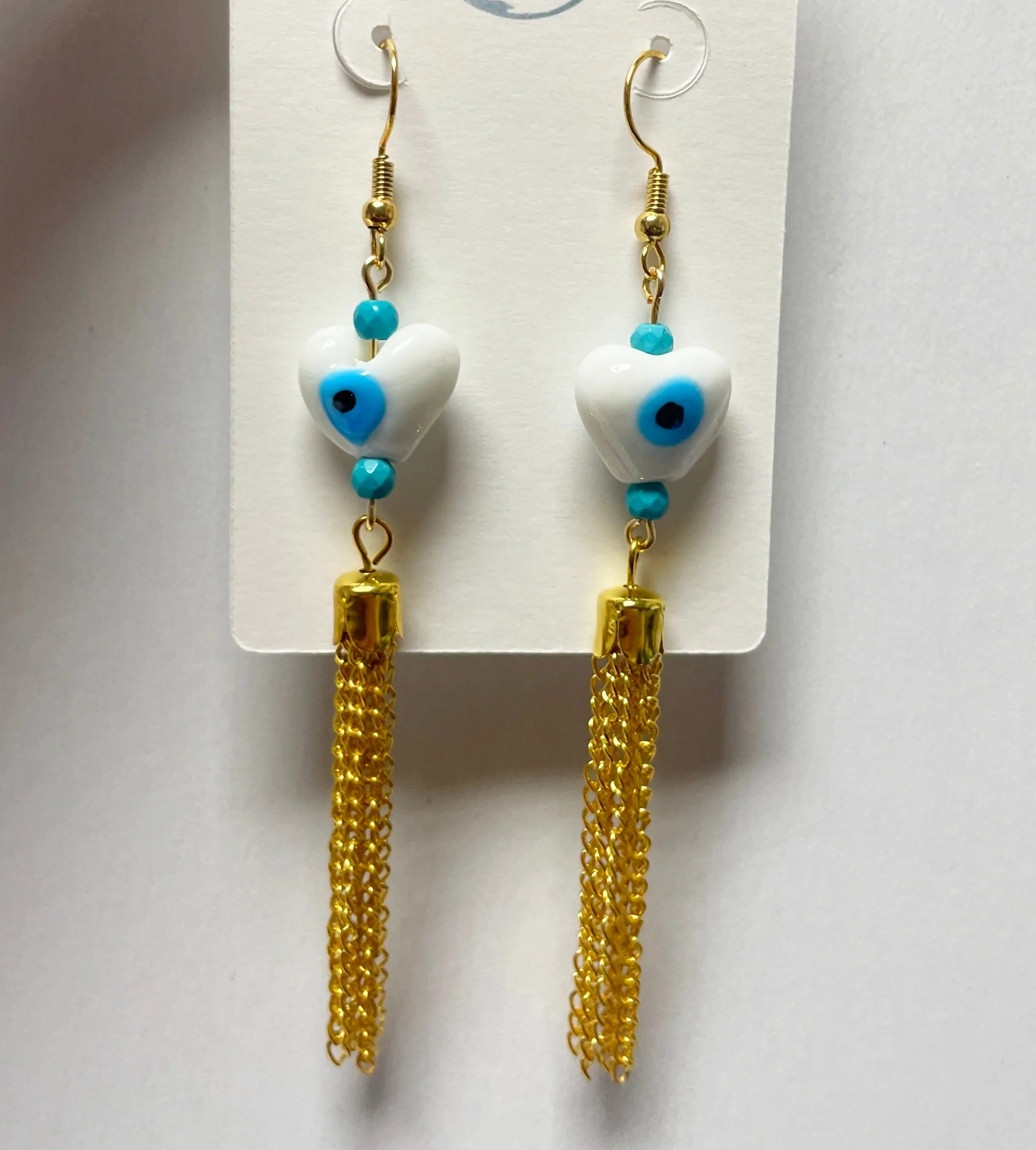 White ojo earrings